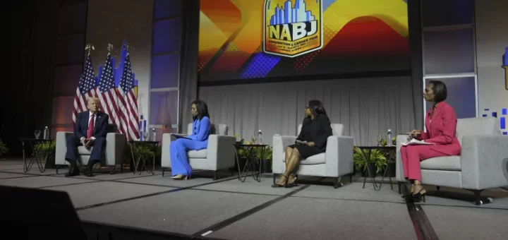 republican presidential nominee and President Donald Trump speaks at a panel moderated by, from left, ABC's Rachel Scott, Semafor's Kadia Goba and Fox News' Harris Faulkner at the National Association of Black Journalists convention Wednesday in Chicago.