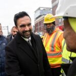 Zohran Mamdani greeting workers at the site of the Williamsburg Bridge bump. (Adam Gray / Bloomberg via Getty Images)